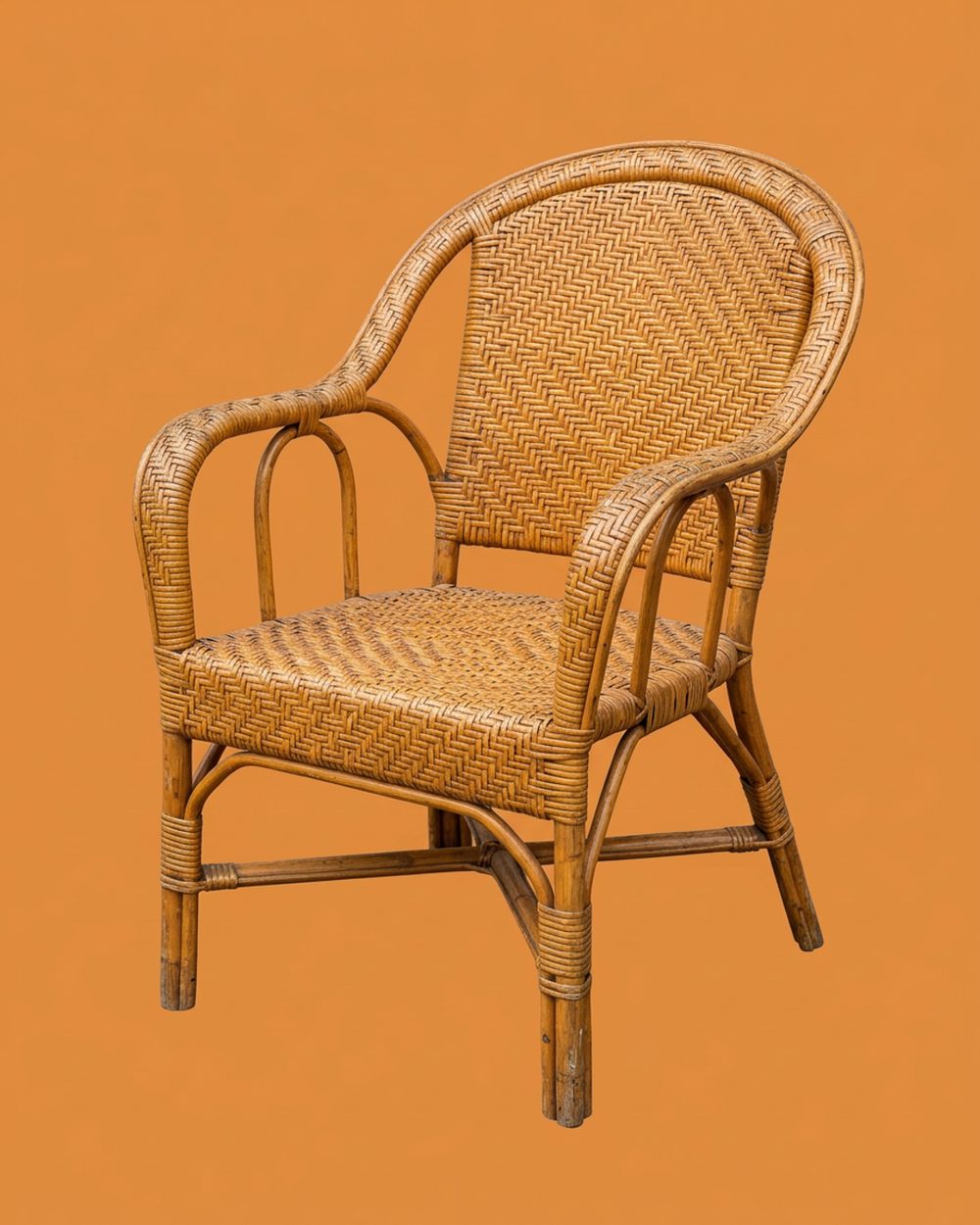 Vintage rattan armchair with a curved woven back, photographed as a cut-out