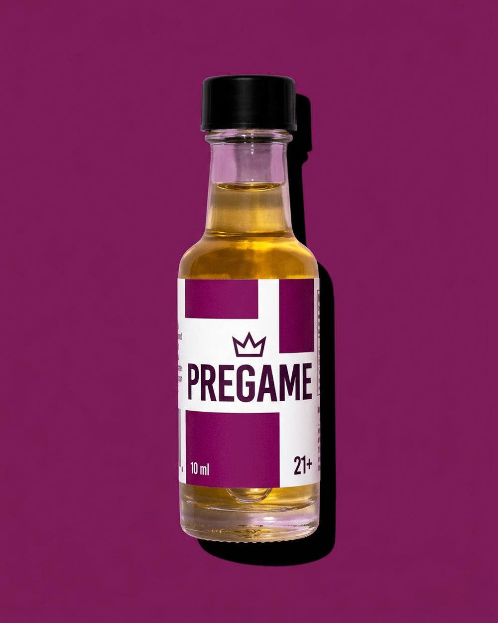 A single 10 ml Pre Game shot bottle with a plum and white label, held against a solid plum background