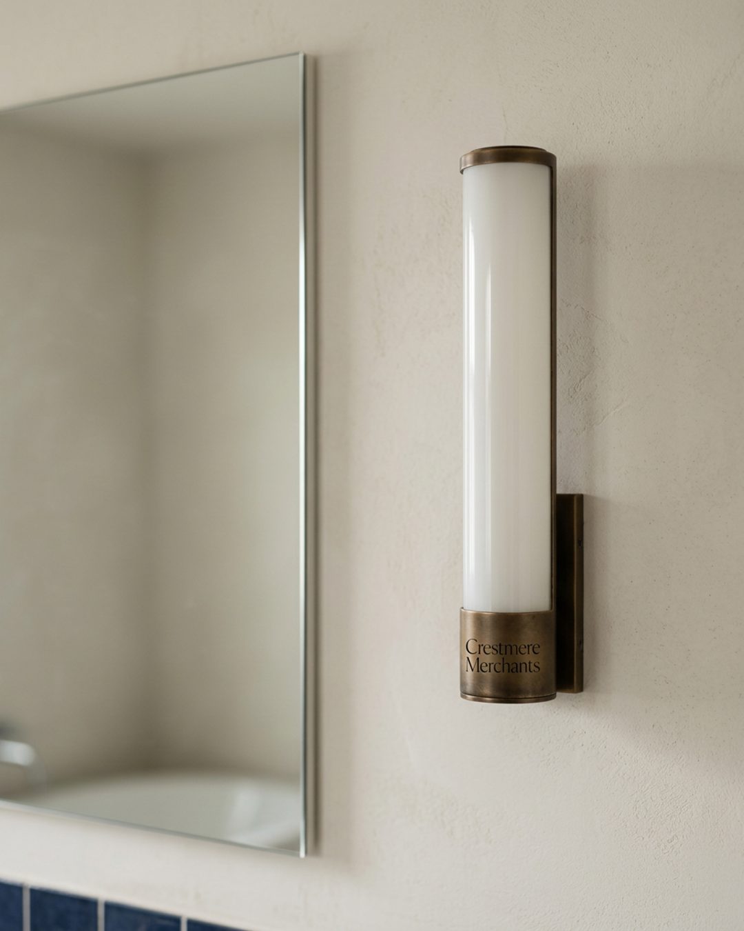 Vanity lighting installed beside a mirror in a finished bathroom