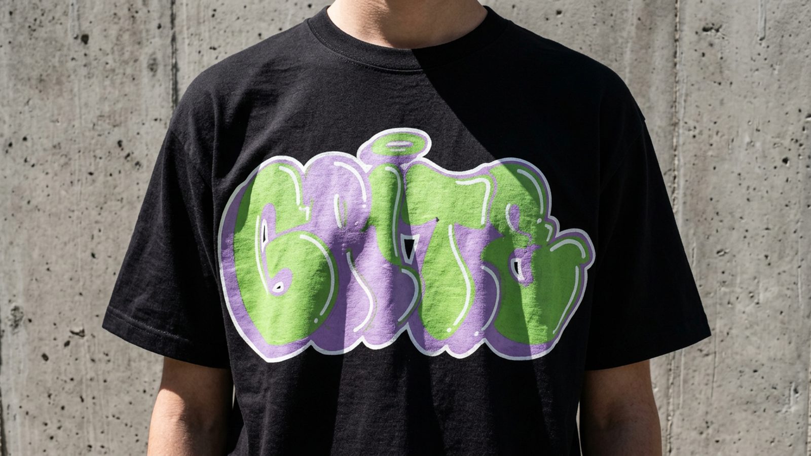 Close crop of a hand-drawn graffiti piece printed on cloth, ink visible in the weave