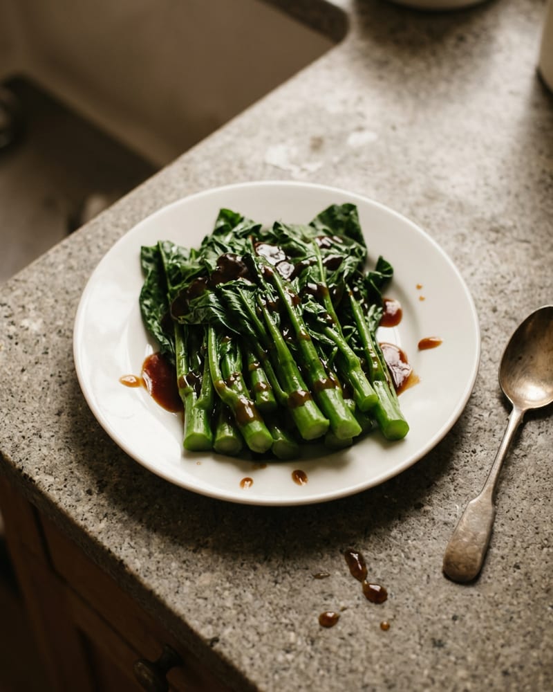A plate of green vegetables glazed with dark oyster sauce