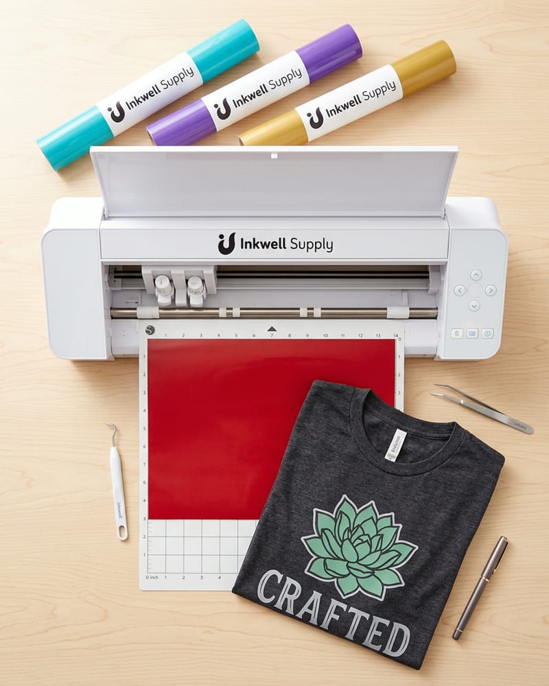 Silhouette Cameo 4 wide-format cutting machine with HTV rolls and a finished custom shirt nearby