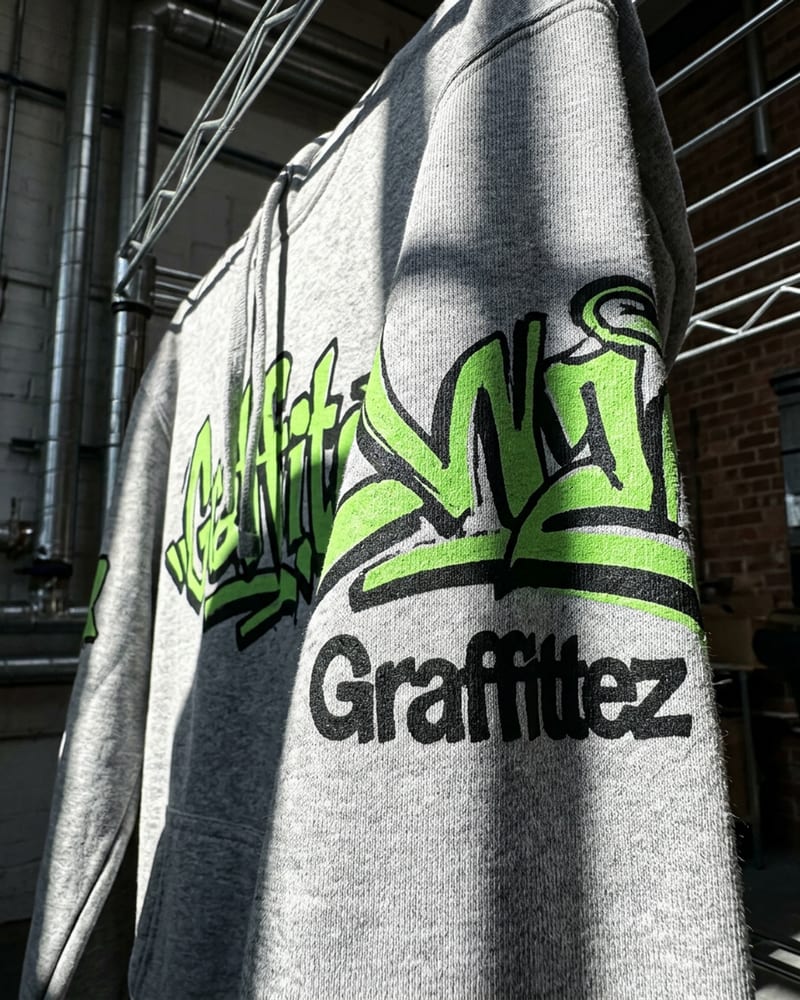 A freshly printed graffiti tee just lifted off the press, ink still wet on the cloth