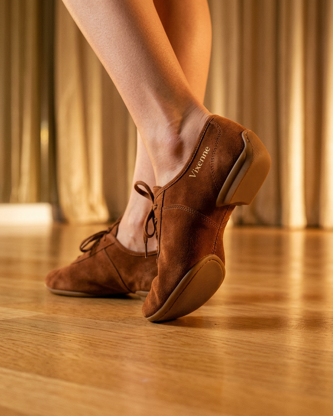 Vixenne dance-to-street shoes on a warm-toned surface with champagne-gold ambient glow, showing sole construction and upper material detail